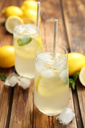 Photo of Natural lemonade with mint on wooden table. Summer refreshing drink