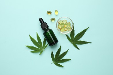 Photo of Flat lay composition with CBD oil or THC tincture and hemp leaves on light blue background