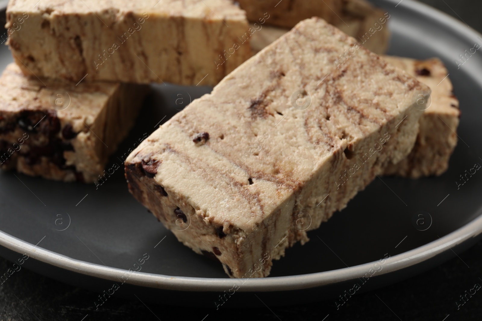 Photo of Plate with tasty chocolate halva on table, closeup