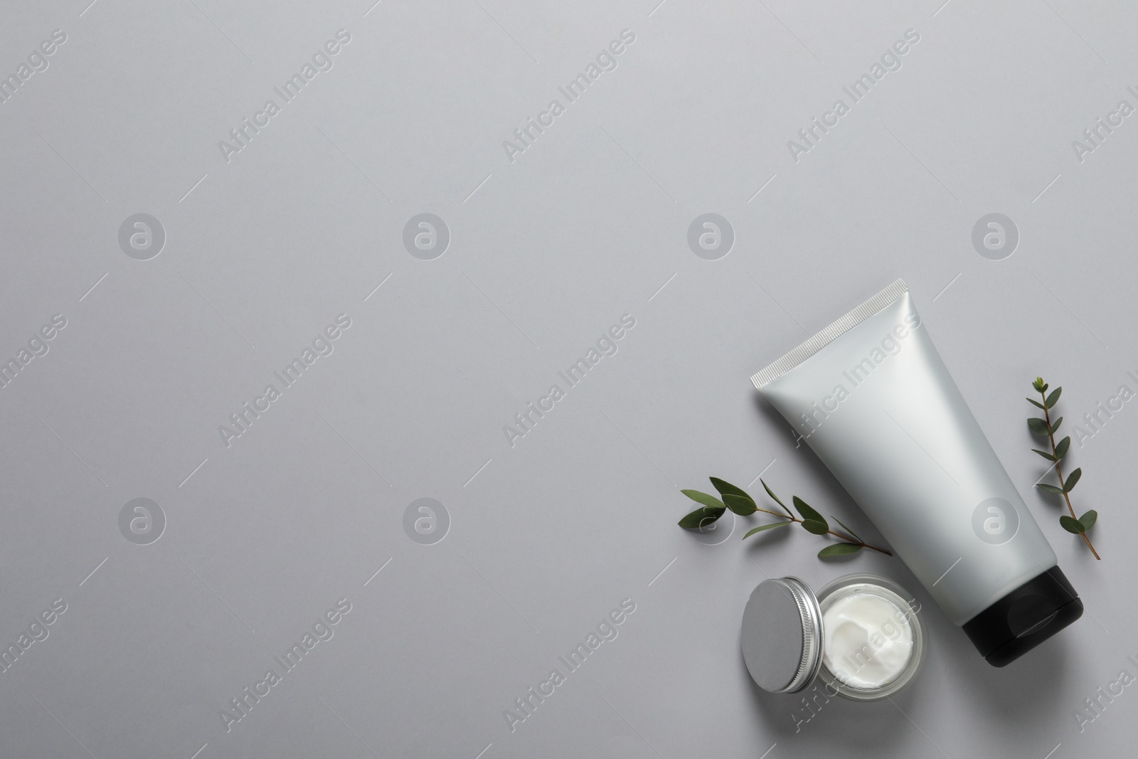 Photo of Tube of men's facial cream on light grey background, flat lay. Space for text