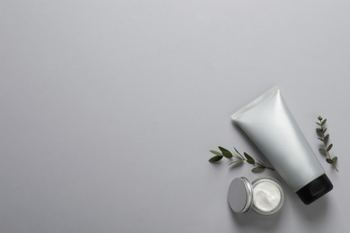 Photo of Tube of men's facial cream on light grey background, flat lay. Space for text