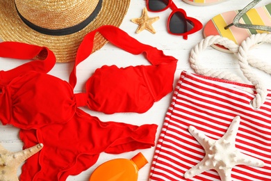 Photo of Flat lay composition with beach objects on white wooden background