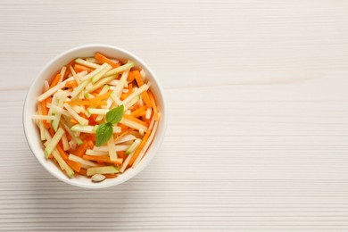 Photo of Delicious turnip salad served on white wooden table, top view. Space for text