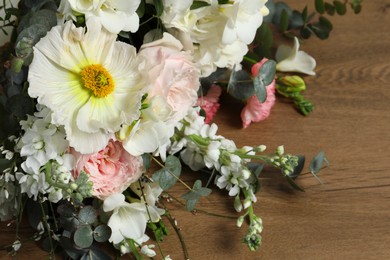 Bouquet of beautiful flowers on wooden table, closeup