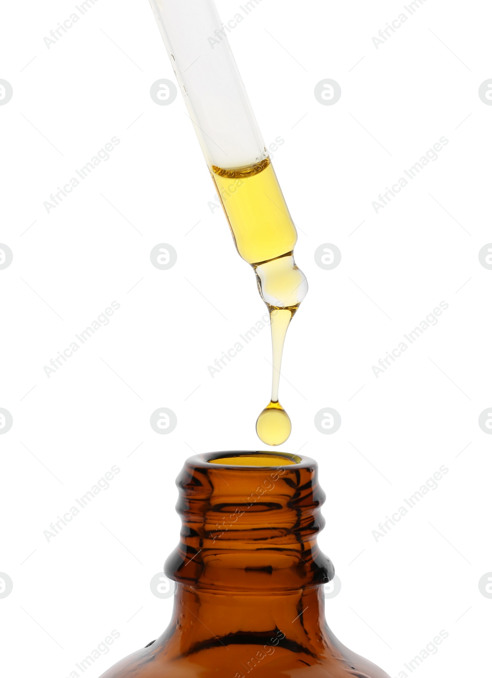 Photo of Dripping tincture from pipette into bottle isolated on white