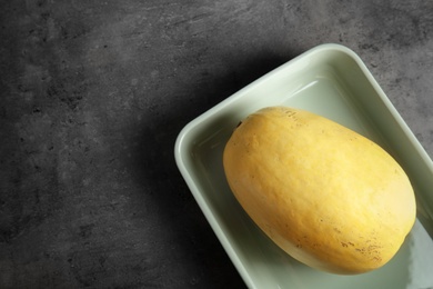 Photo of Baking dish with spaghetti squash on gray table, top view. Space for text