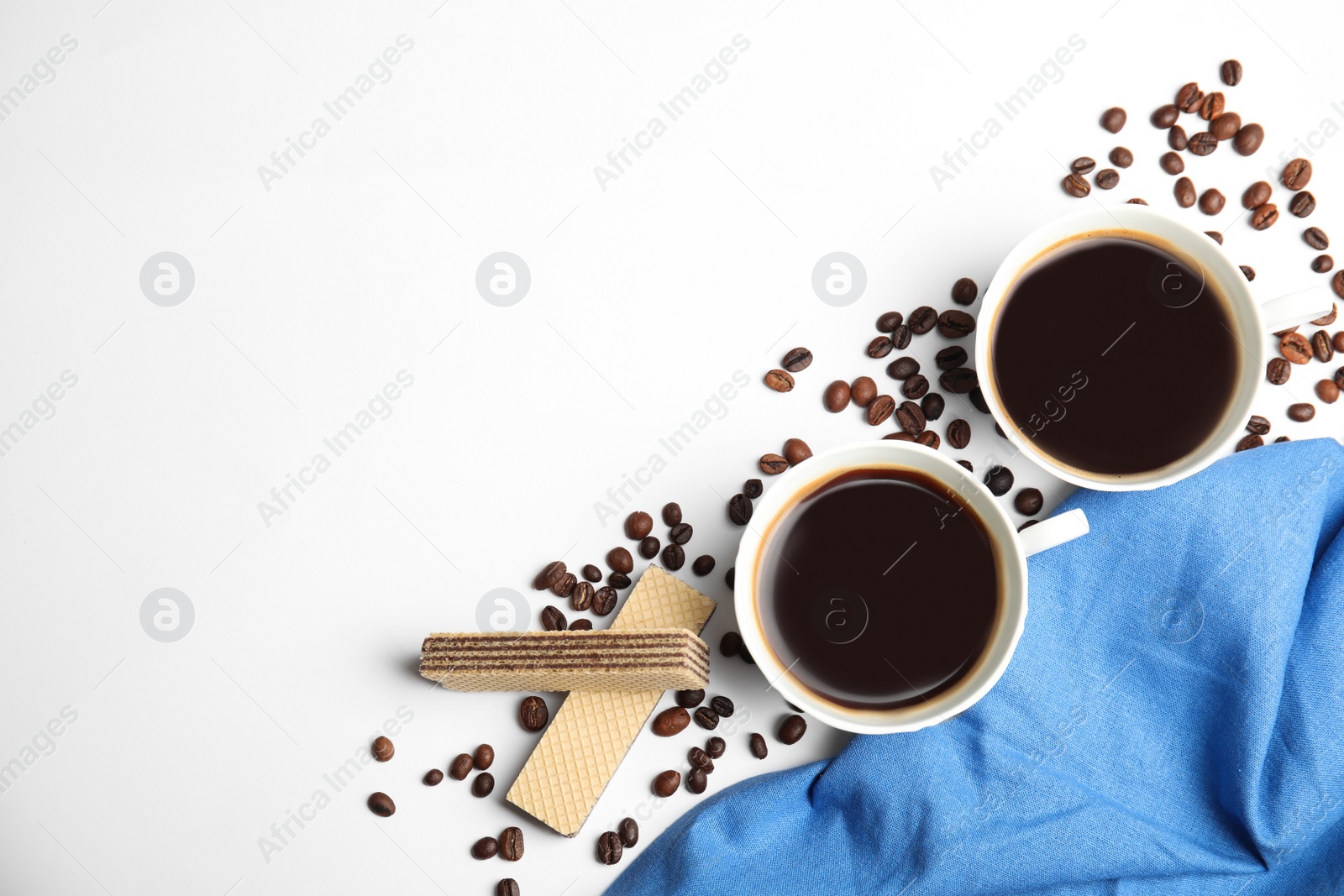 Photo of Breakfast with delicious wafers and coffee on white background, flat lay. Space for text