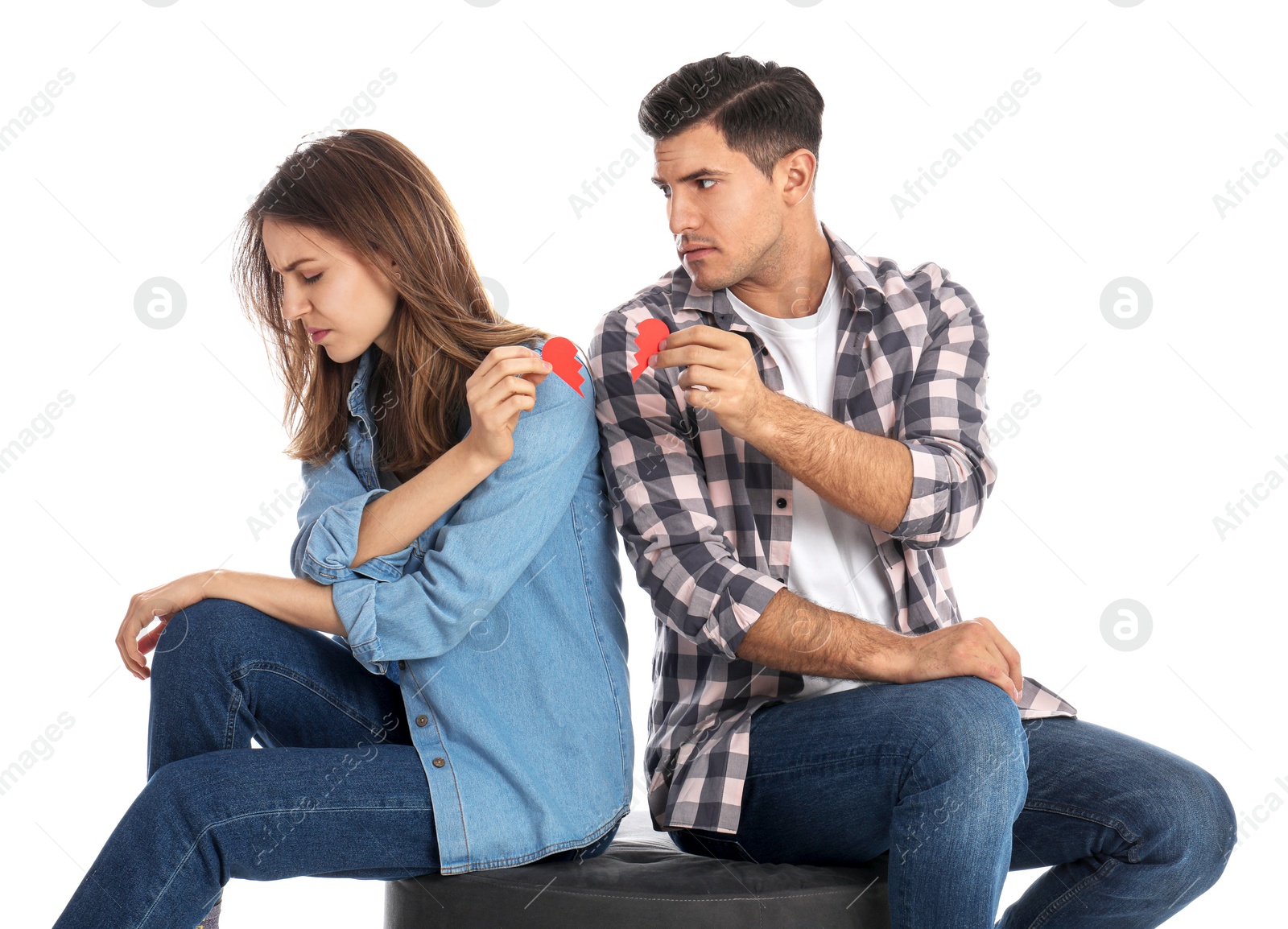 Photo of Couple with torn paper heart on white background. Relationship problems