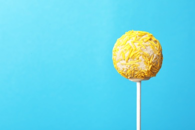 Yummy bright cake pop on color background. Space for text