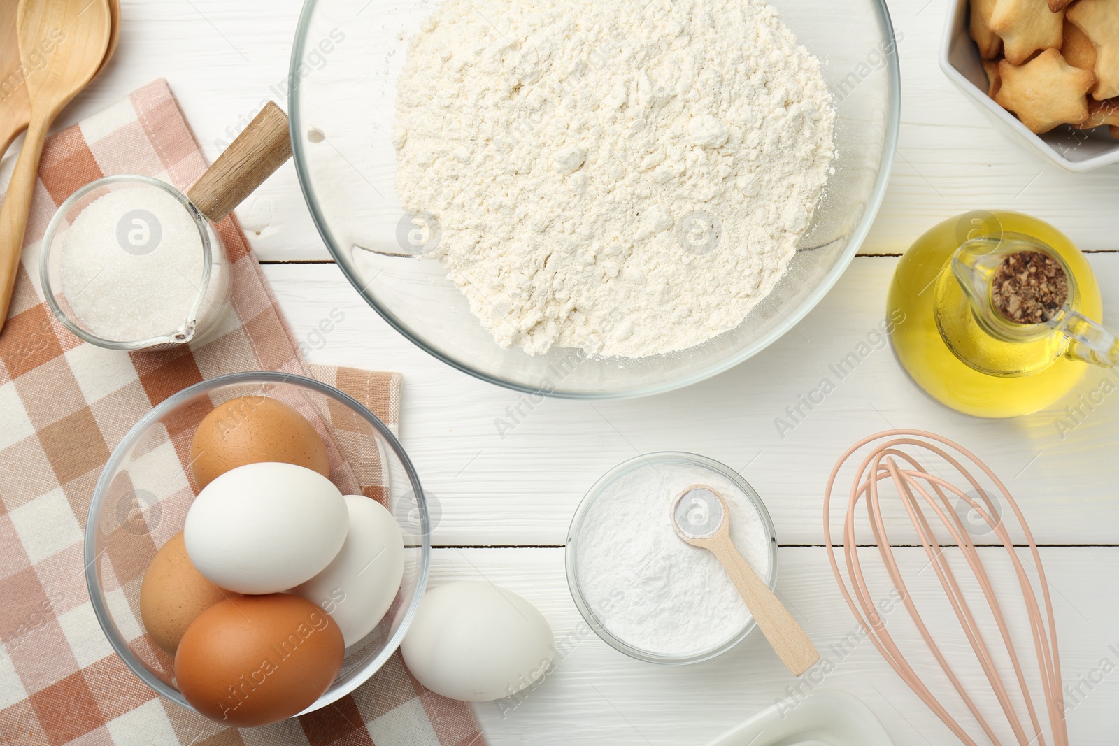 Photo of Flat lay composition with baking powder and products on white wooden table