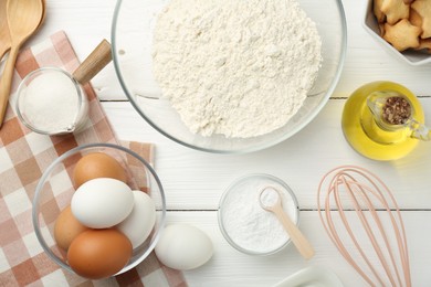 Photo of Flat lay composition with baking powder and products on white wooden table