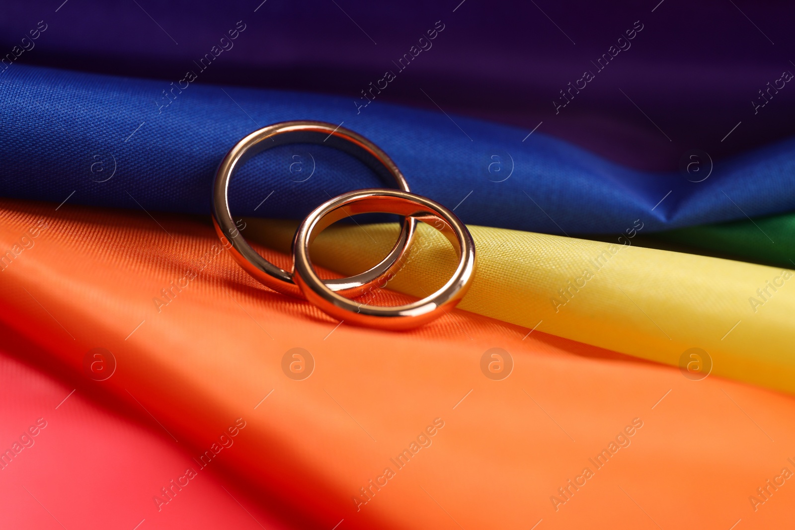 Photo of Wedding rings on rainbow LGBT flag, closeup