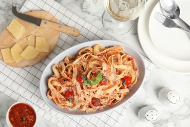 Flat lay composition with tasty pasta on white marble table