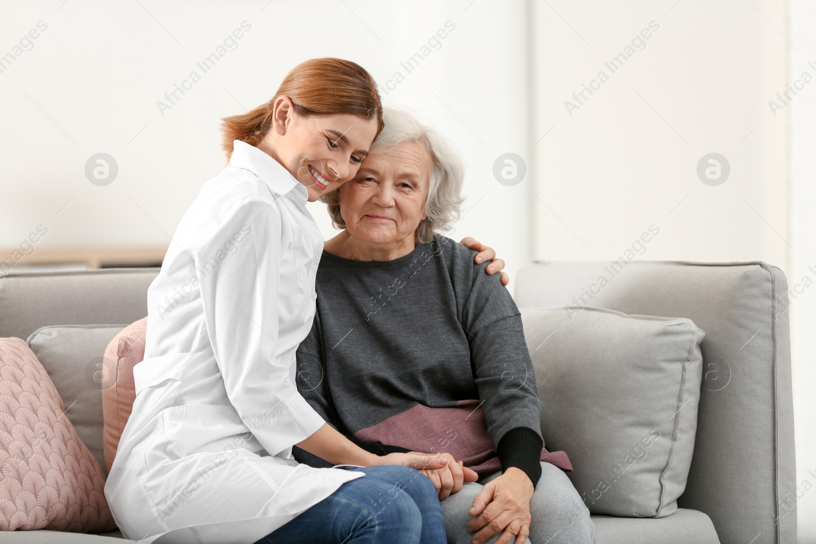 Photo of Elderly woman with female caregiver in living room