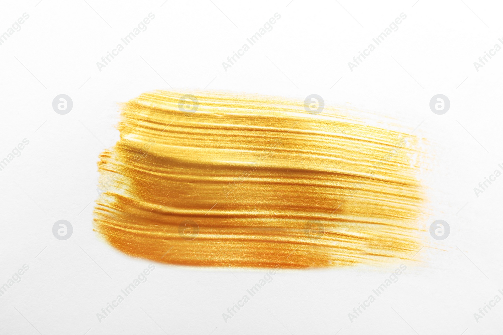 Photo of Stroke of gold paint isolated on white, top view