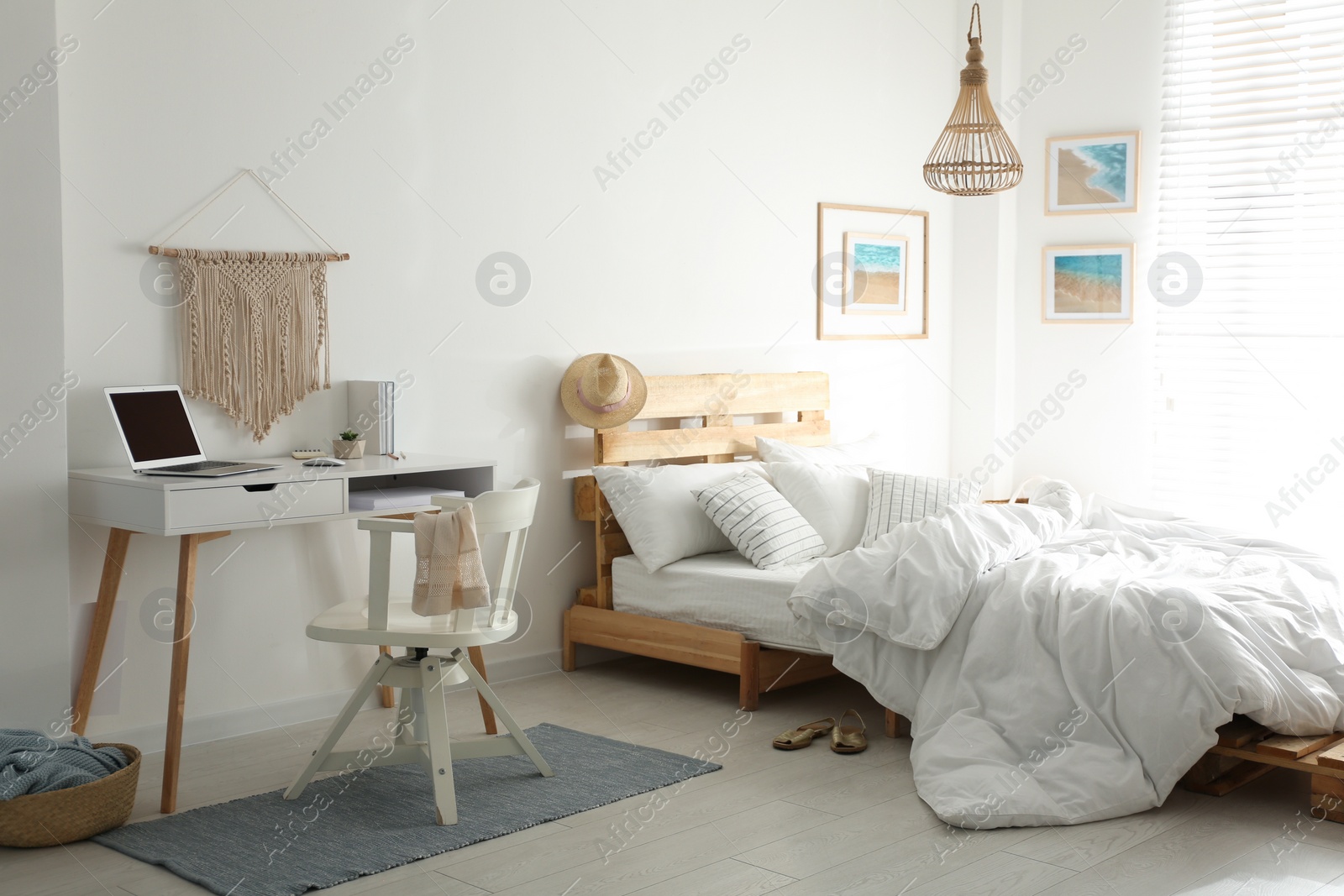 Photo of Stylish room interior with workplace and bed