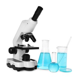 Laboratory glassware with light blue liquid and microscope isolated on white