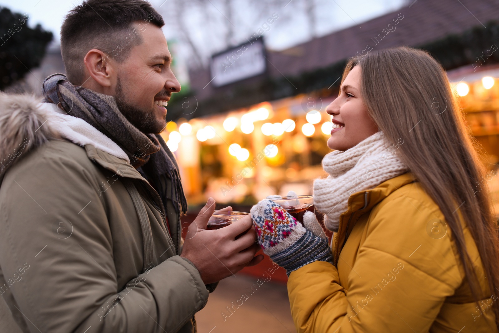 Photo of Happy couple with mulled wine at winter fair