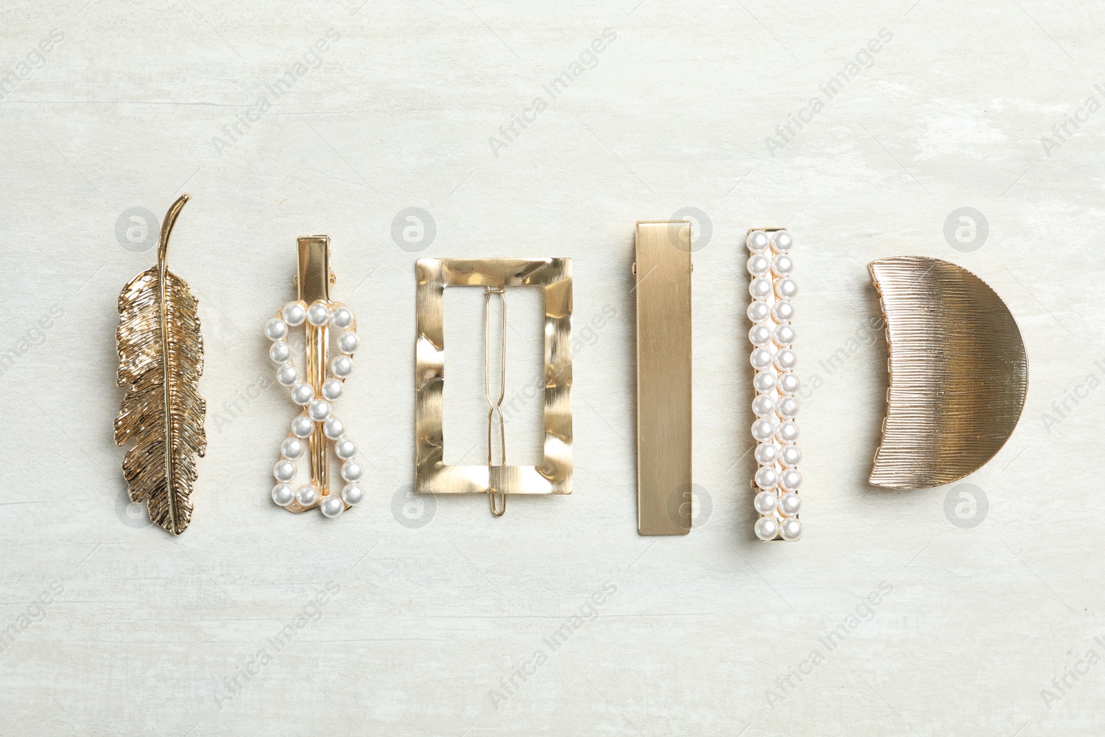 Photo of Beautiful different hair clips on white table, flat lay