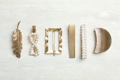 Beautiful different hair clips on white table, flat lay