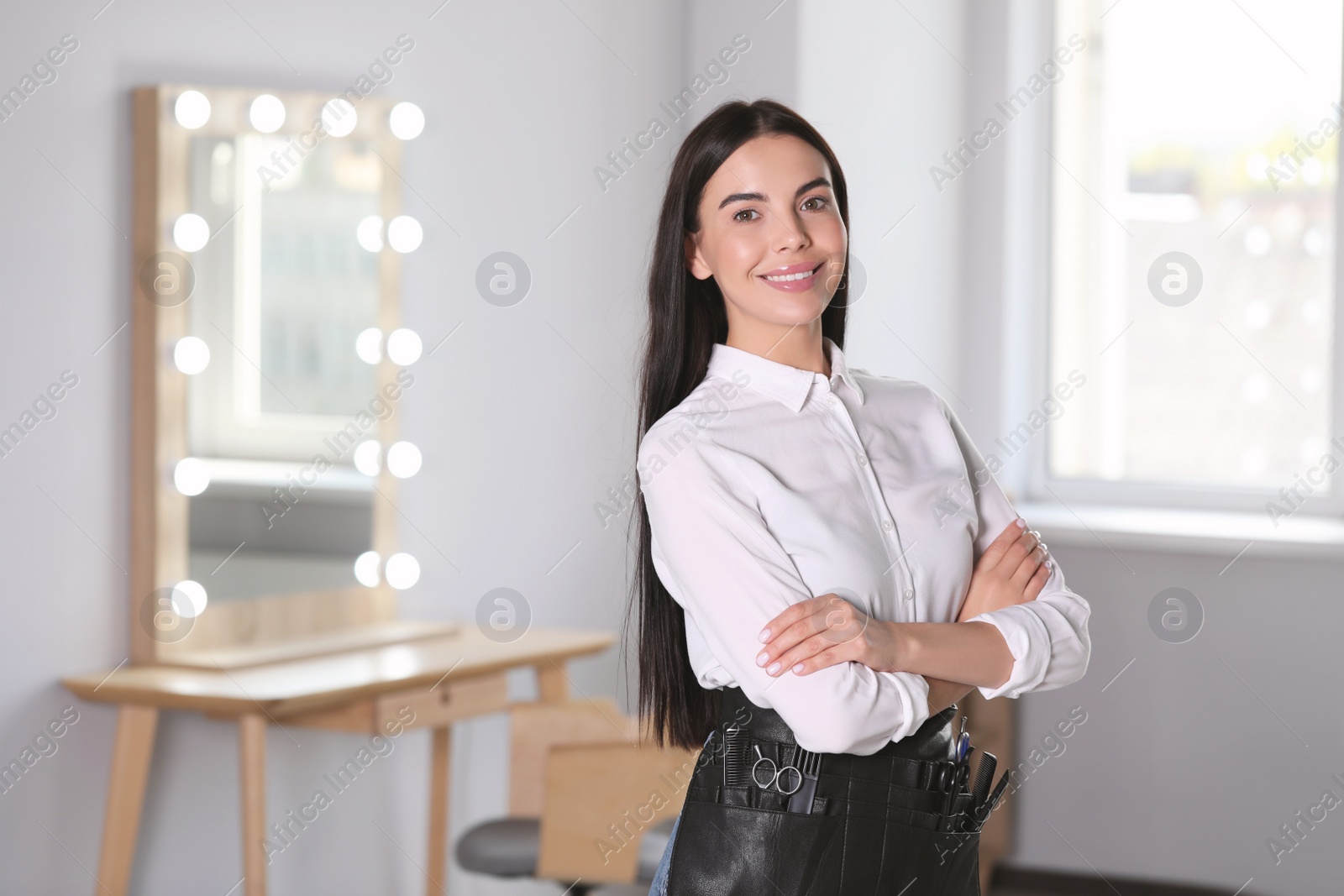 Photo of Portrait of professional hairdresser in beauty salon, space for text