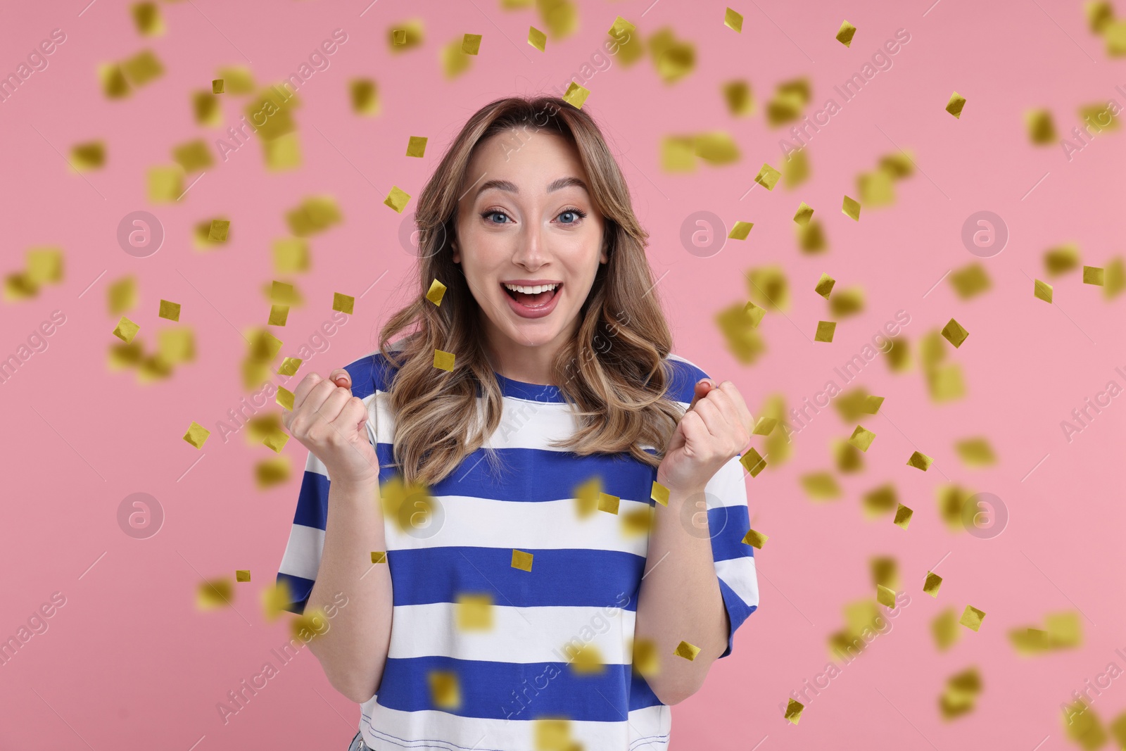 Image of Happy woman and flying confetti on pink background