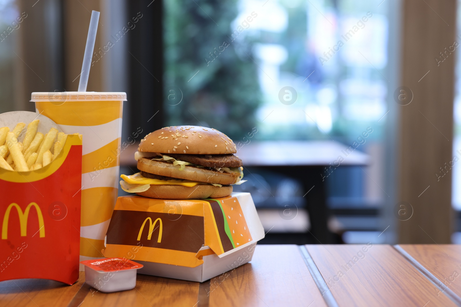 Photo of Lviv, Ukraine - October 9, 2023: McDonald's menu on wooden table in restaurant, space for text