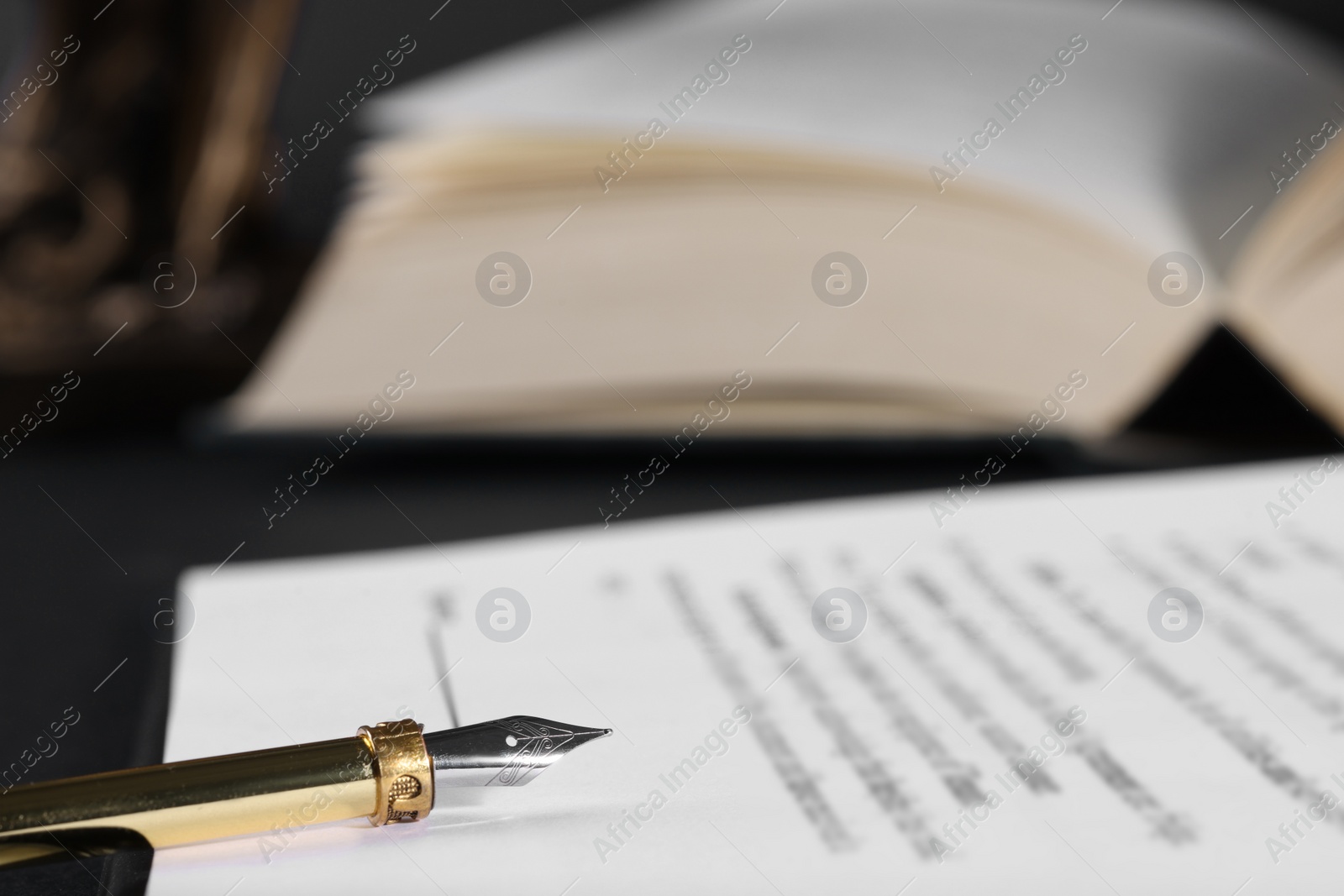 Photo of Fountain pen and paper document on table, closeup with space for text. Notary service