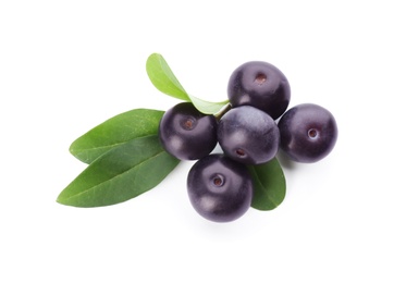 Photo of Pile of fresh acai berries with leaves isolated on white, top view