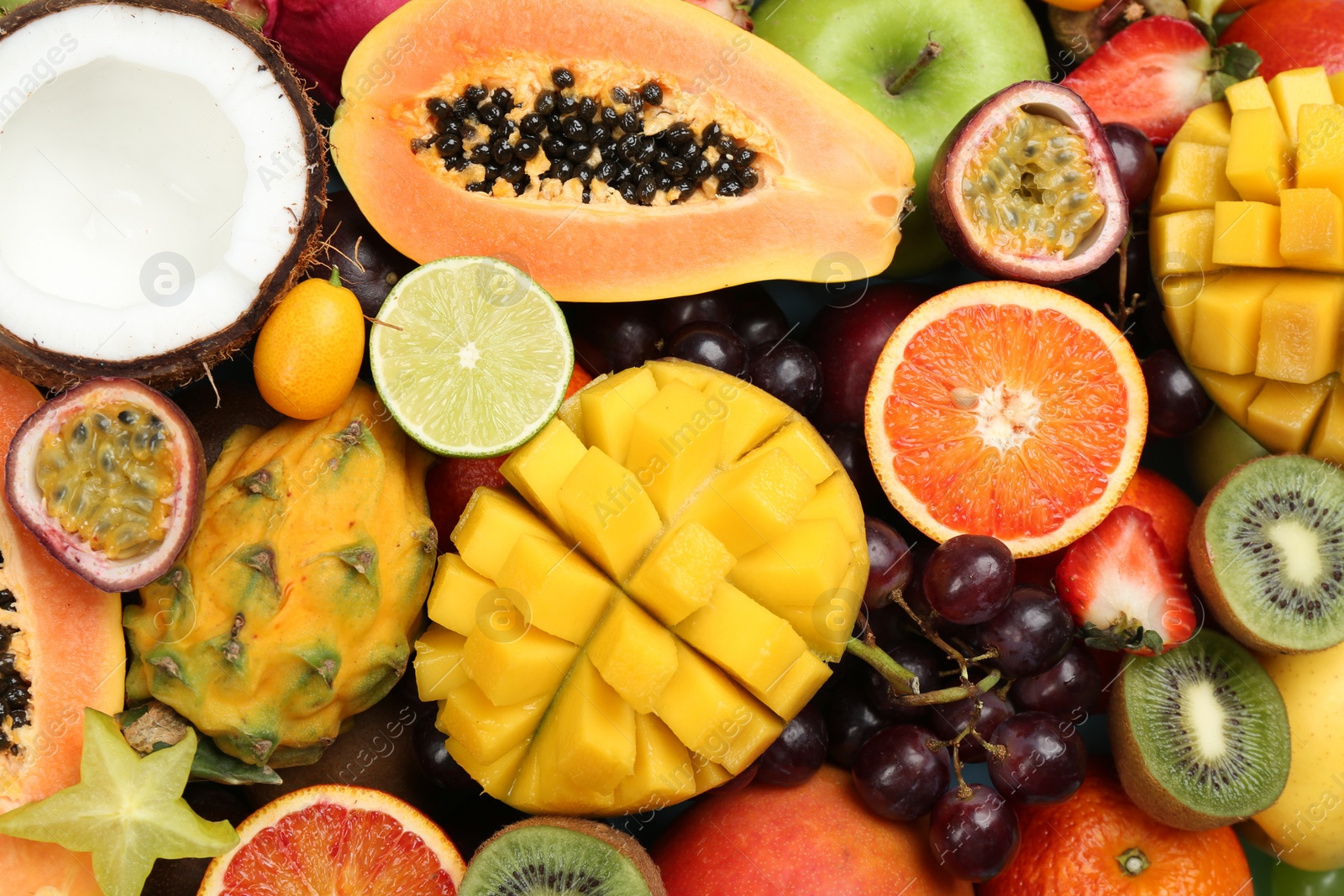 Photo of Many different delicious exotic fruits as background, top view