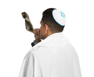 Photo of Jewish man with kippah and tallit blowing shofar on white background. Rosh Hashanah celebration