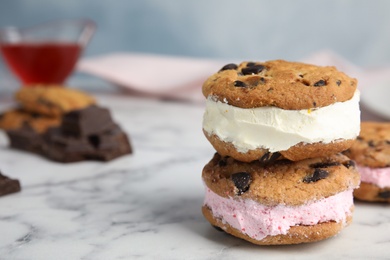 Photo of Sweet delicious ice cream cookie sandwiches on table, space for text