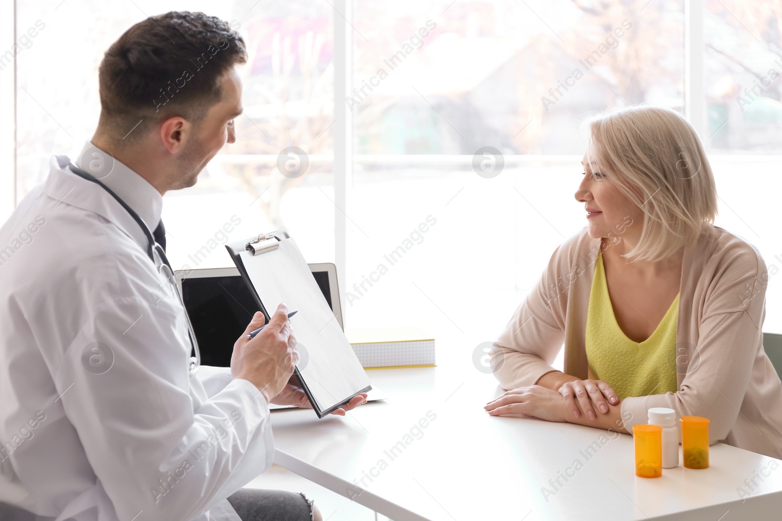 Photo of Male doctor consulting patient in clinic