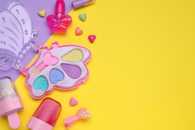 Photo of Children's kit of makeup products and accessories on color background, flat lay. Space for text