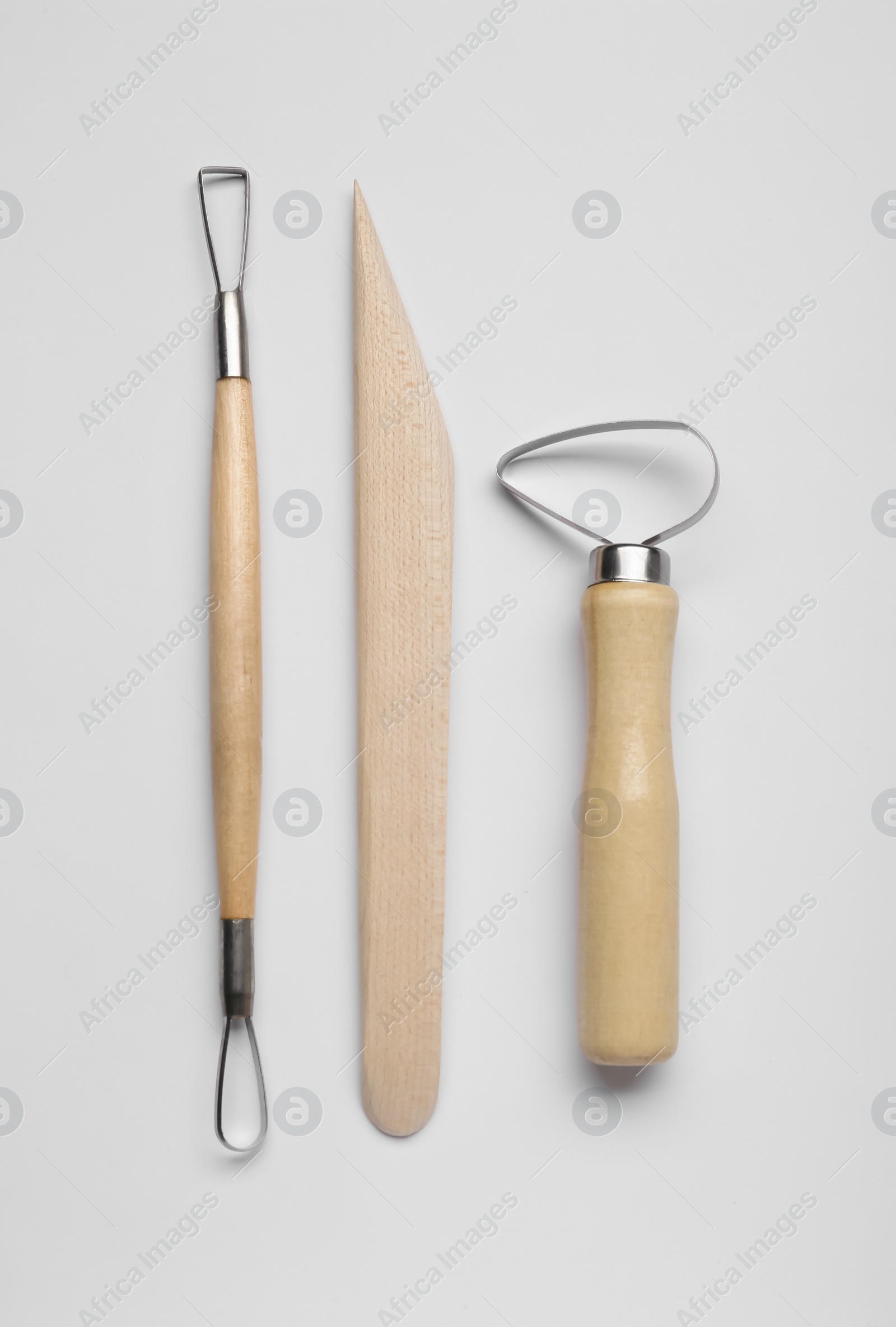 Photo of Set of clay modeling tools on white background, flat lay