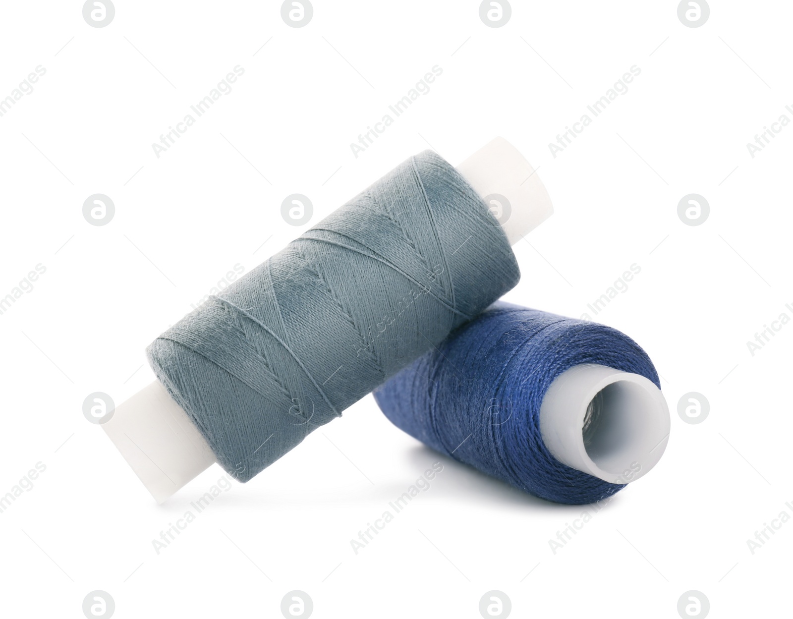 Photo of Different colorful sewing threads on white background