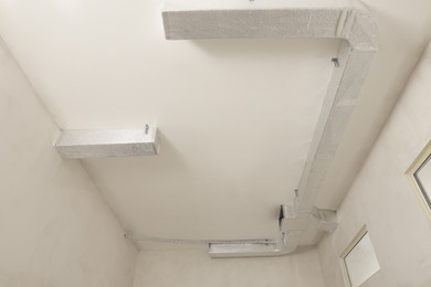 New ventilation system on beige ceiling indoors