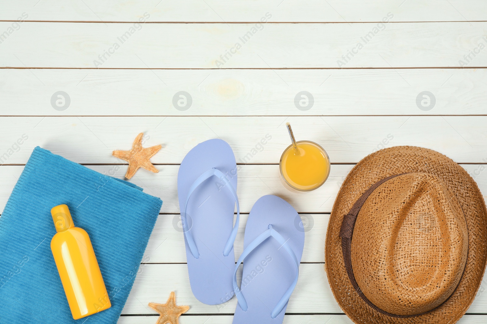 Photo of Flat lay composition with beach objects on white wooden background, space for text