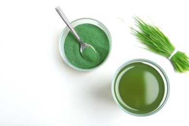 Composition with glass of spirulina drink on white background, top view