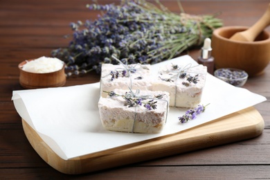 Photo of Hand made soap bars with lavender flowers on wooden table