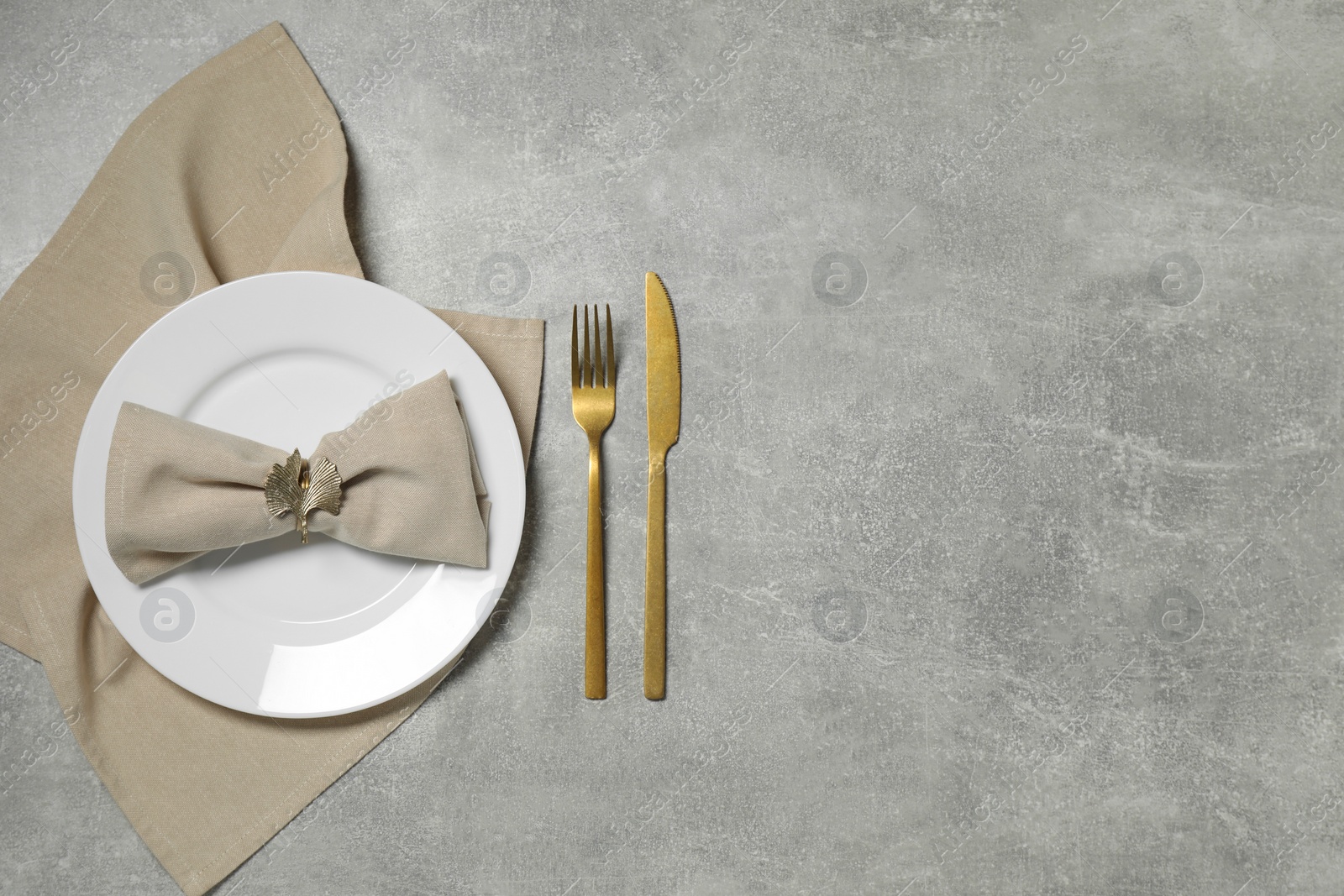 Photo of Stylish setting with elegant cutlery on grey table, flat lay. Space for text