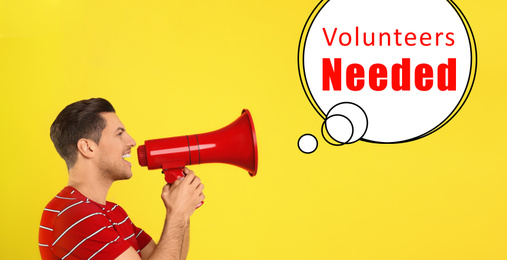 Image of Young man with megaphone and text VOLUNTEERS NEEDED on yellow background