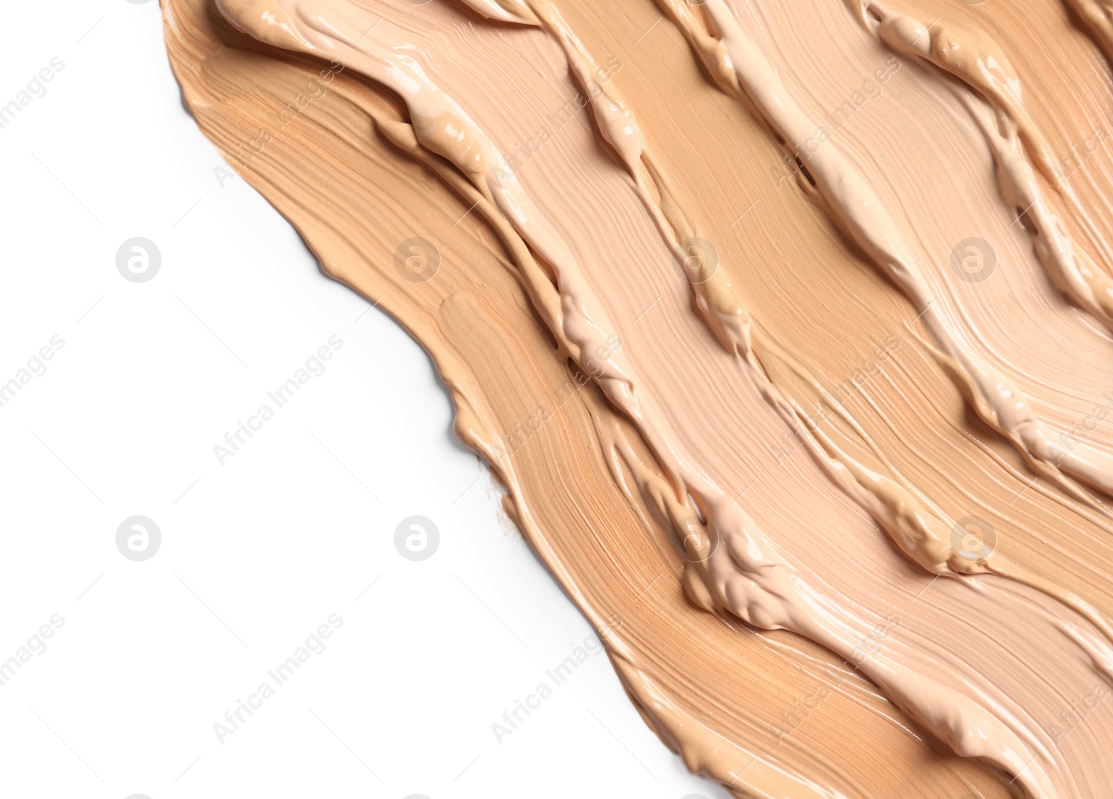 Photo of Samples of skin foundation on white background, closeup. Space for text