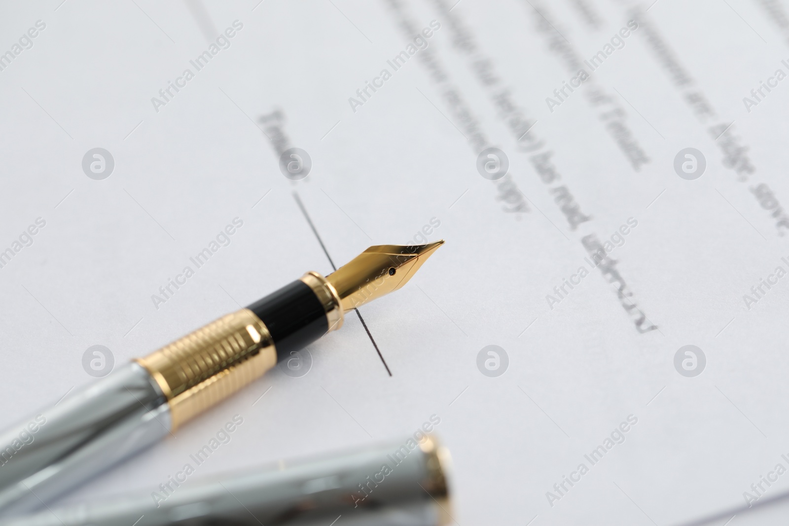 Photo of Fountain pen on paper document, closeup. Notary services