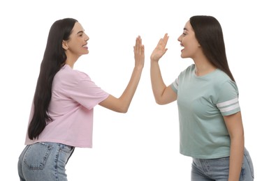 Women giving high five on white background