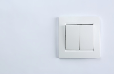 Photo of Light switch on white background. Electrician's equipment