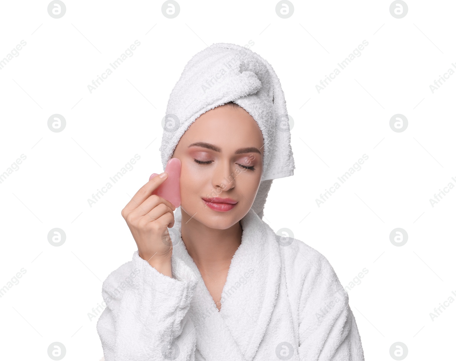 Photo of Young woman massaging her face with rose quartz gua sha tool isolated on white