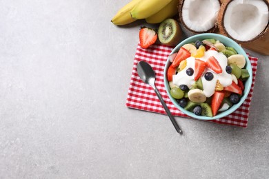 Photo of Delicious fruit salad on grey table, flat lay. Space for text