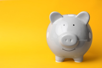 Photo of Gray piggy bank on color background. Money saving