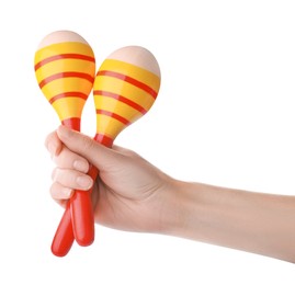 Photo of Woman holding colorful maracas on white background, closeup. Musical instrument